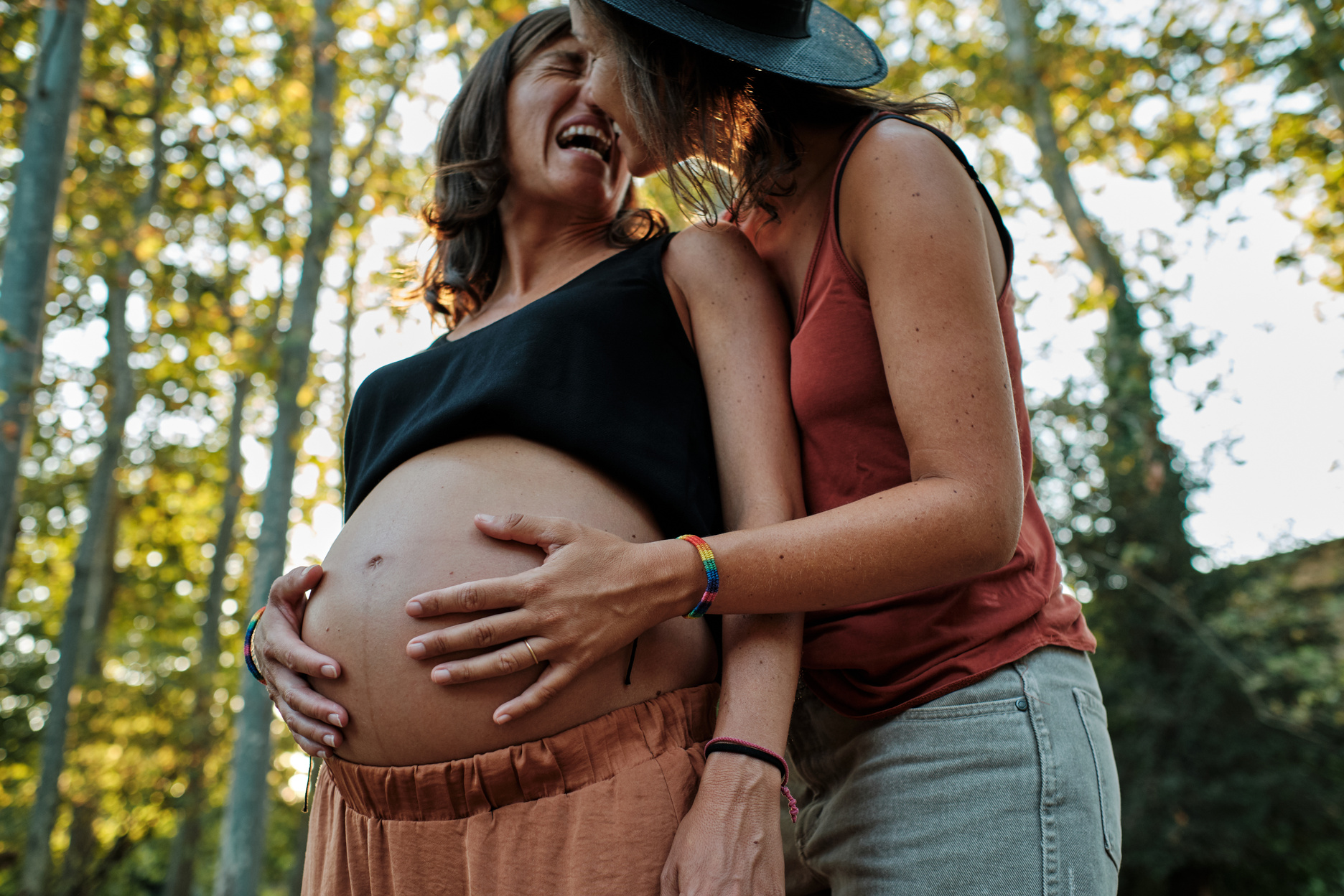 Woman Embracing Her Pregnant Partner 